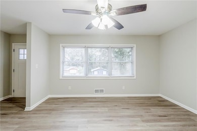 Empty room featuring light hardwood / wood-style flooring and ceiling fan