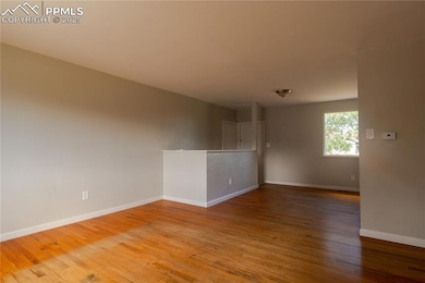 Empty room featuring wood finished floors and baseboards