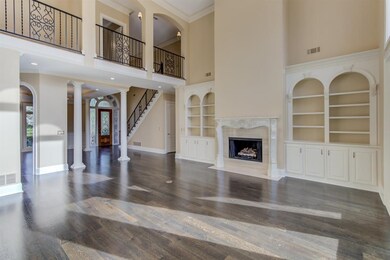 Two-story living room with iron railing and views 