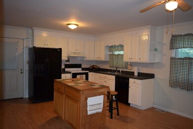 Spacious kitchen with island.  Island is moveable and has a drop down bar.