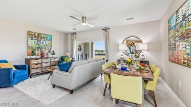 Living room with ceiling fan and light hardwood /
