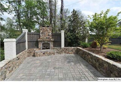 The stone patio and custom fireplace make a perfec