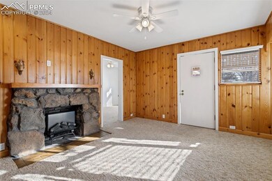 Rustic fireplace with period light sconces above.