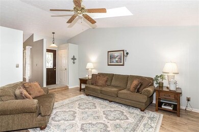 Enter into the spacious living room with a cathedral ceiling and skylights!