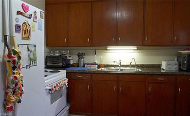 New laminate floors, Formica counters, sink and fixtures in 2017.  Freestanding stove and refrigerator belong to the tenant and do not remain with the home.