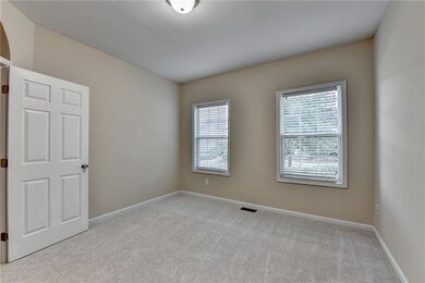 Unfurnished room featuring light carpet