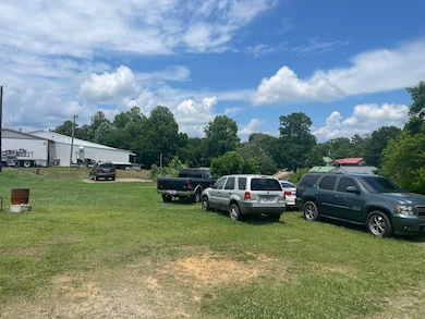 View of parking / parking lot with a lawn