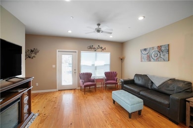 Living room featuring baseboards, light wood-type 