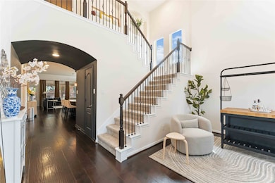 Stunning entry with wood flooring, art niches, and