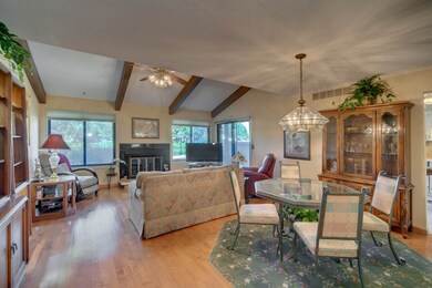 Open floor plan with vaulted wood beam ceiling and