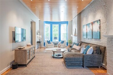 Museum quality lighting in the family room make this space a delight for any art enthusiast to entertain their guests.