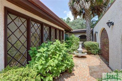 Front courtyard with gardens and fountain.