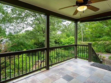 Relax on the whimsical tile front porch and enjoy the view of the gardens.