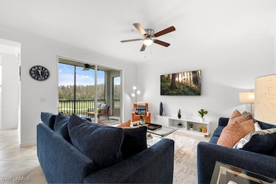Living area featuring ornamental molding, a ceiling fan, and light tile patterned floors