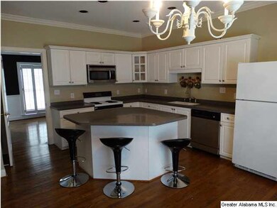 Large kitchen w/ island and breakfast bar.