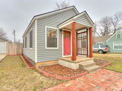 View of front of home with a garage and a front ya