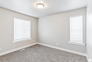 Carpeted empty room with baseboards