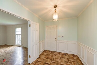 Foyer with wood floors, wainscoting and open to th