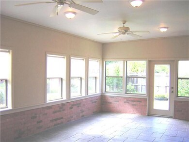 A very tasteful sunroom addition is located behind