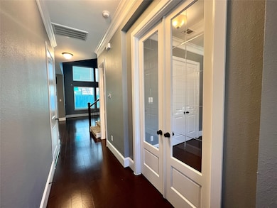 Wood flooring flows from the entrance throughout t