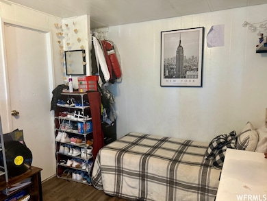 View of bedroom with entrance into first full bathroom