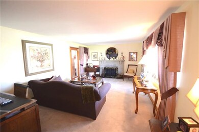 SPACIOUS LIVING ROOM WITH STONE FIREPLACE, CARPET 