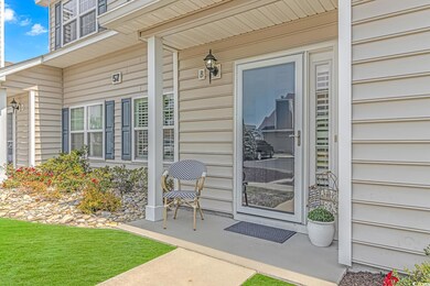 Doorway to property featuring covered porch