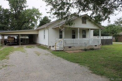 Generous 2 car attached carport with a door into the house under cover