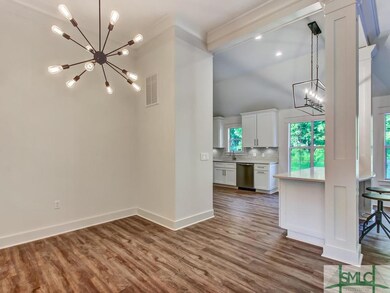 Dining area, sputnik chandelier and kitchen area -