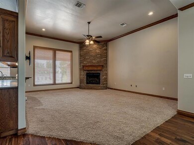 Unfurnished living room with ceiling fan, dark woo