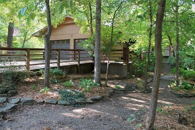 Front/side view, all sides of home are beautifully landscaped. Long drive, can park in this side graveled area as well.