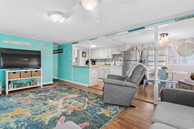 Living room featuring wood-type flooring, sink, a 