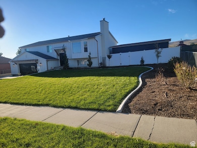 View of front of home featuring a chimney and a gate