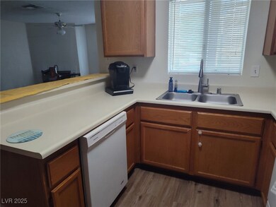 Kitchen featuring dishwasher, light countertops, a