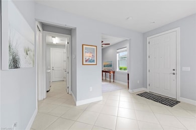 Foyer, den to left of foyer, hall leads to laundry and garage