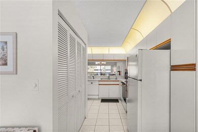 Kitchen featuring a notable chandelier, light tile
