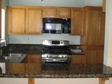 Stove and Microwave looking form dining area