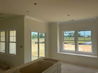 Kitchen featuring crown molding and white cabinetry