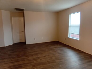 Empty room with visible vents and dark wood finish