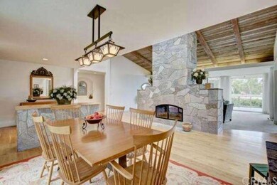 Central, two-sided fireplace separating the dining