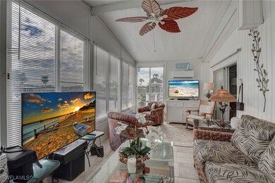 Sunroom featuring lofted ceiling with beams & ceil