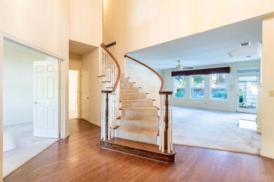Stairs with ceiling fan and wood-type flooring