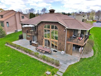 Wall Full of windows in the back of the home for pristine water views. Door on lower left takes you to workshop offering storage for kayaks and outdoor equipment, sliders to both bedrooms, deck to the side - all with water views.