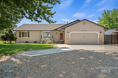 Single story home with driveway, an attached garage, and stone siding