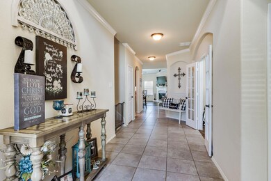 Large entry hall to living spaces.  Peek double doors into dining area!