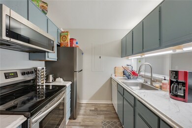 Kitchen with stainless steel appliances, a sink, b