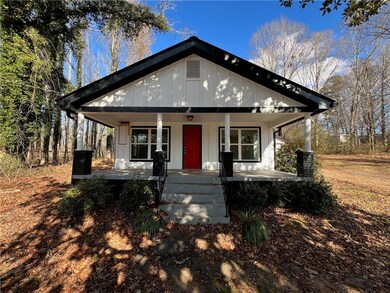 View of front facade with a porch and board and ba