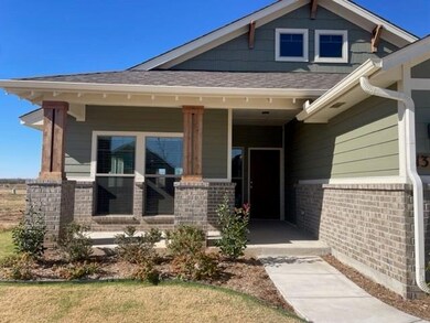 View of exterior entry with a porch, a shingled ro