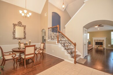 This elegant entrance greets you once you first open the door.  Gorgeous wrought iron railing and amazing floors!