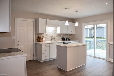 Tile backsplash and a sliding door to the deck.